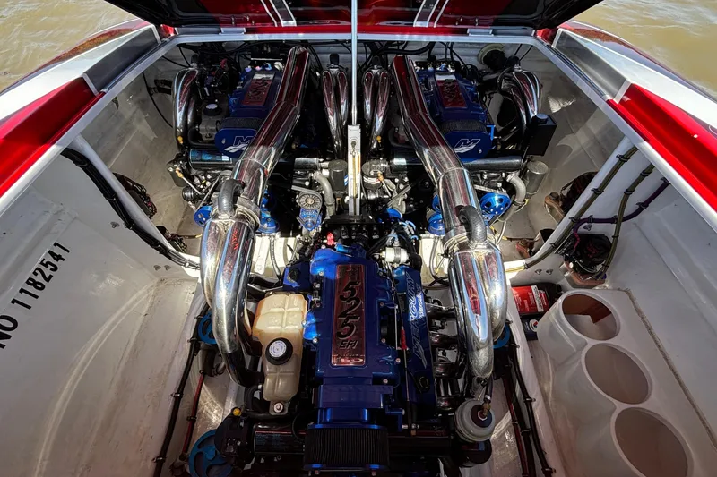 Slide: The Image of Engine compartment of a 2004 Outerlimits 42 Legacy boat, showcasing powerful dual engines. - 53