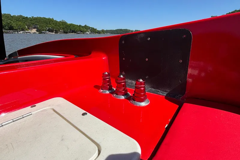 Slide: The Image of Red 2004 Outerlimits 42 Legacy boat deck with cleats, near a scenic lake. - 55