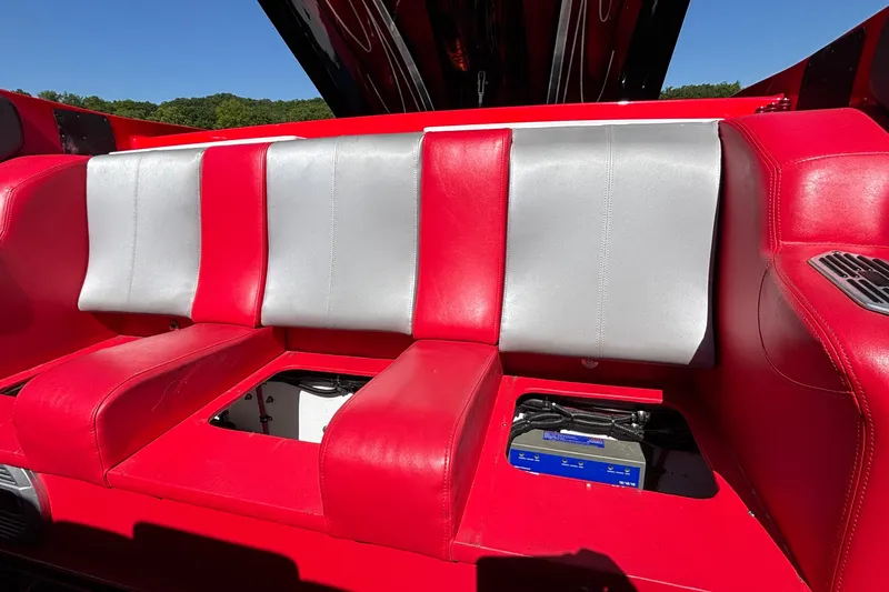 Slide: The Image of Red and silver seating on a 2004 Outerlimits 42 Legacy boat, showcasing vibrant upholstery. - 56