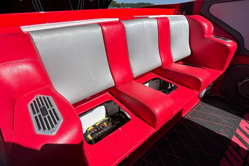 Slide: The Image of Red and gray seating in a 2004 Outerlimits 42 Legacy boat interior. - 57