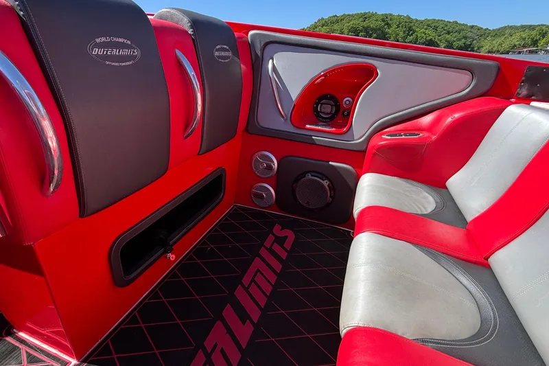 Slide: The Image of Interior of a 2004 Outerlimits 42 Legacy boat with red and gray seating. - 58