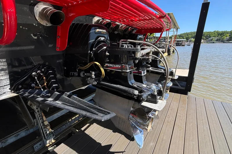Slide: The Image of 2004 Outerlimits 42 Legacy boat with Mercury Racing engines docked by the water. - 65