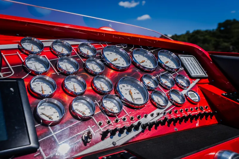 Slide: The Image of Dashboard of a 2004 Outerlimits 42 Legacy boat with multiple gauges and controls. - 27