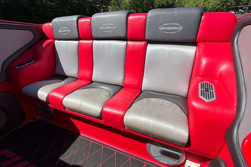 Slide: The Image of Red and gray leather seating in a 2004 Outerlimits 42 Legacy boat interior. - 8