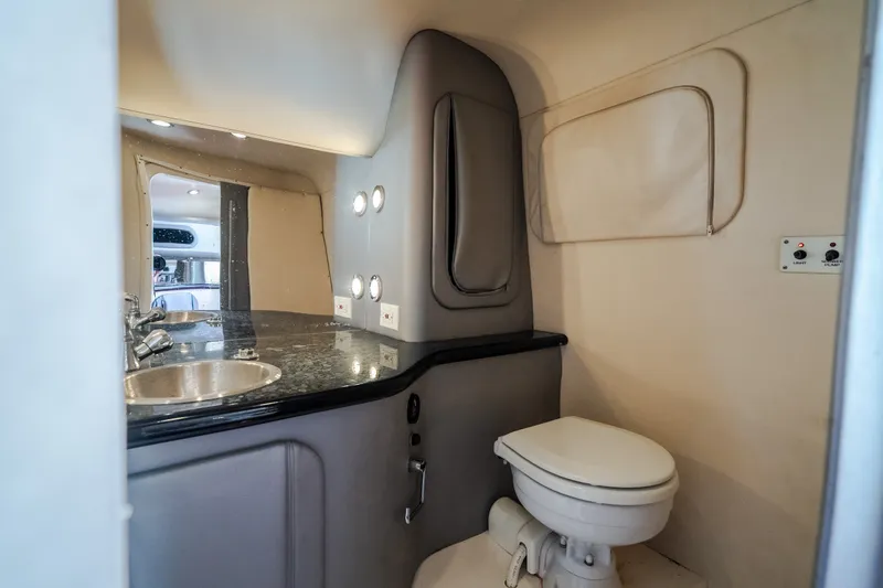 Slide: The Image of 2004 Outerlimits 42 Legacy boat bathroom with sink, toilet, and mirror. - 38