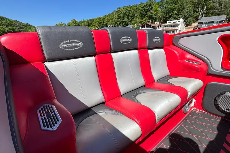 Slide: The Image of Red and gray seating in a 2004 Outerlimits 42 Legacy boat interior. - 9
