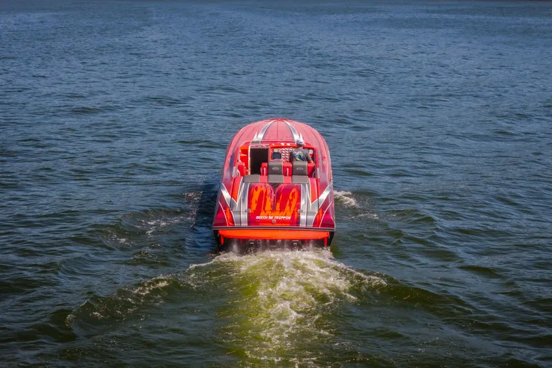 Slide: The Image of Red 2004 Outerlimits 42 Legacy speedboat cruising on open water. - 46