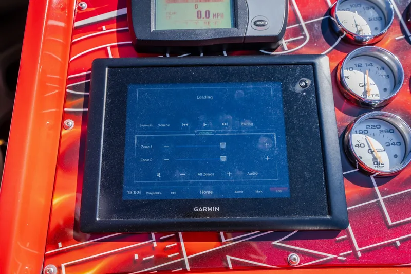 Slide: The Image of Garmin navigation system on 2004 Outerlimits 42 Legacy boat dashboard with gauges. - 32