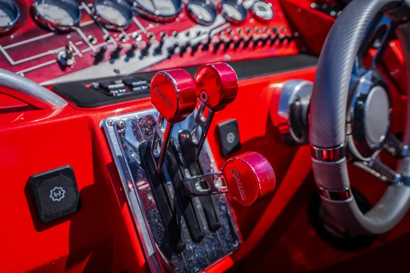 Slide: The Image of Red dashboard of 2004 Outerlimits 42 Legacy boat with controls and steering wheel. - 25