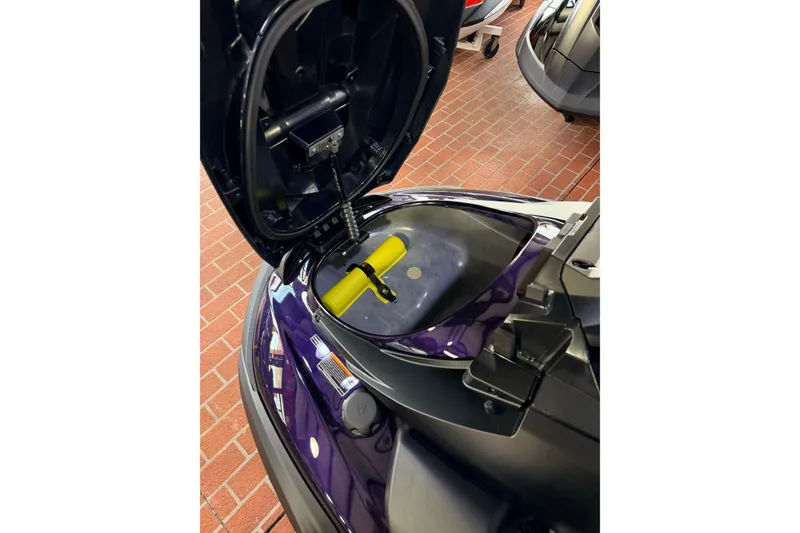 Slide: The Image of 2026 Yamaha WaveRunner FX SVHO with open storage compartment on brick floor. - 12