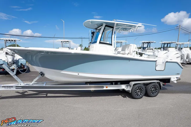 Slide: The Image of 2026 Sea Hunt Ultra 265 SE boat on trailer, displayed outdoors under clear blue sky. - 11