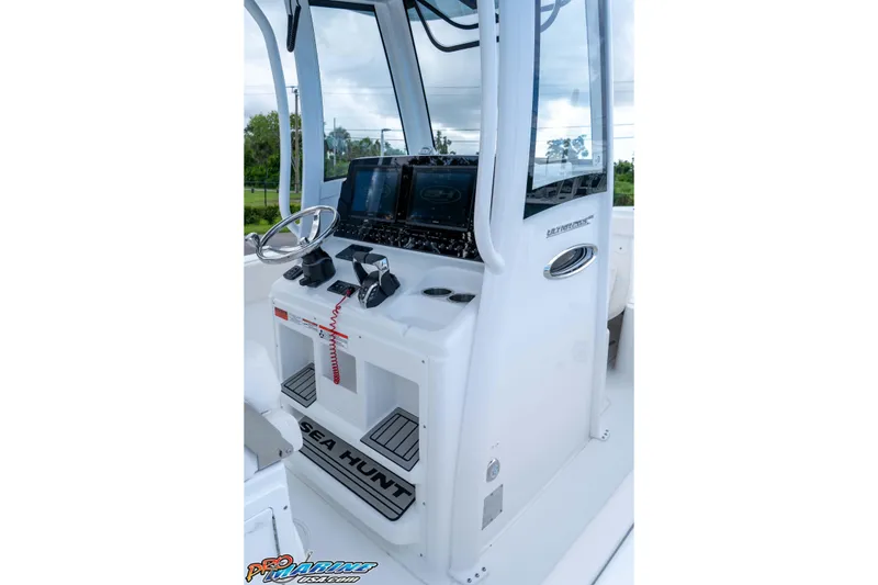Slide: The Image of 2026 Sea Hunt Ultra 265 SE boat console with steering wheel and controls. - 16