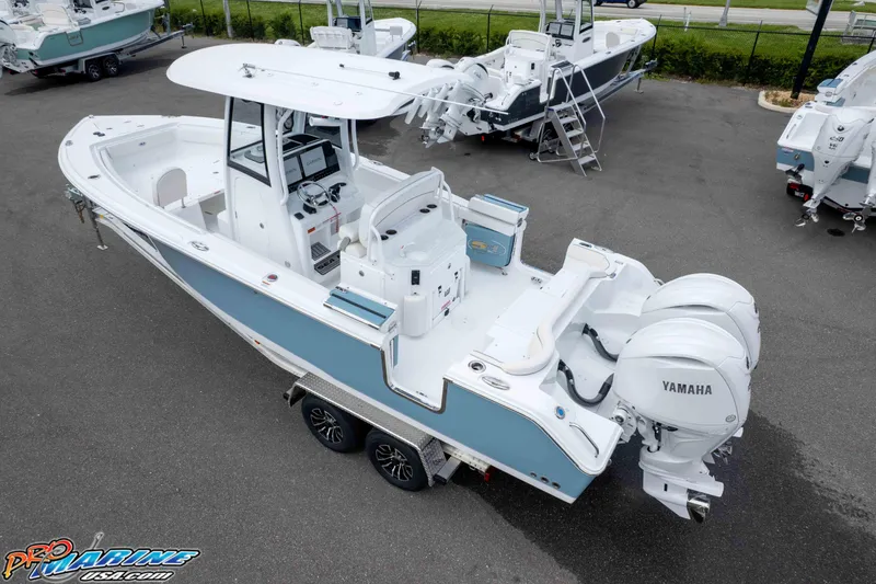 Slide: The Image of 2026 Sea Hunt Ultra 265 SE boat with dual Yamaha engines, parked on a trailer. - 17