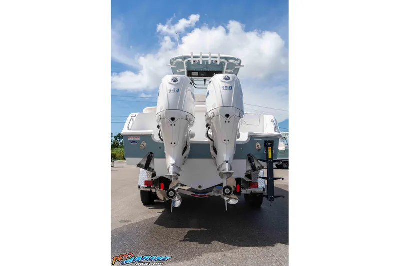 Slide: The Image of 2026 Sea Hunt Ultra 265 SE boat with dual outboard engines, parked on a trailer. - 43
