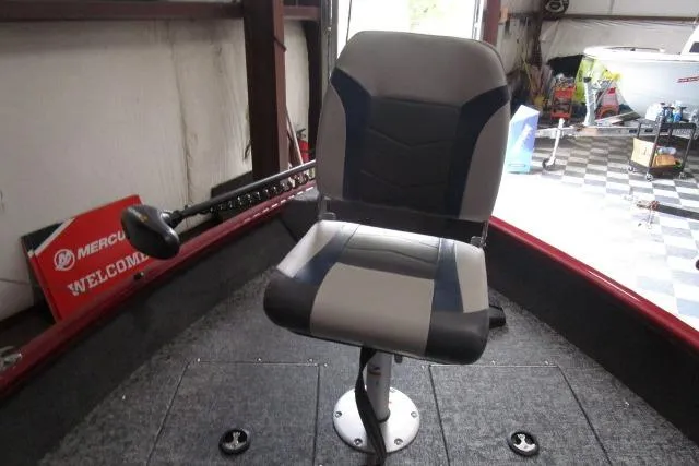 Slide: The Image of 2024 Tracker Pro Guide V-16 WT boat interior with a swivel seat and carpeted floor. - 4