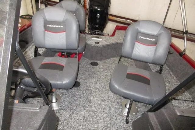 Slide: The Image of 2024 Tracker Pro Guide V-16 WT boat interior with four gray seats and carpeted flooring. - 5