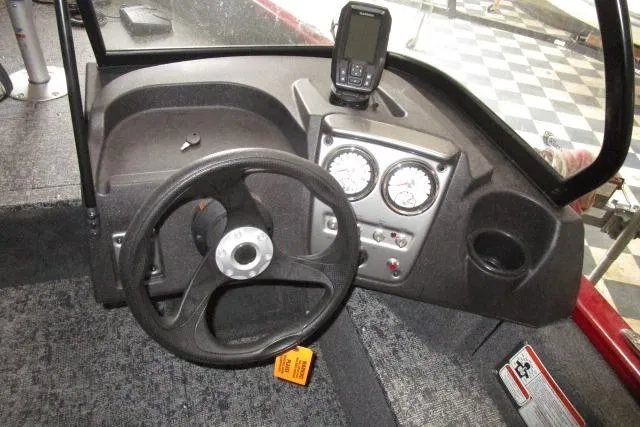 Slide: The Image of 2024 Tracker Pro Guide V-16 WT boat dashboard with steering wheel and gauges. - 6