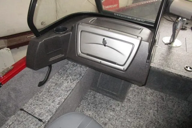 Slide: The Image of 2024 Tracker Pro Guide V-16 WT boat interior with glove compartment and seating. - 7