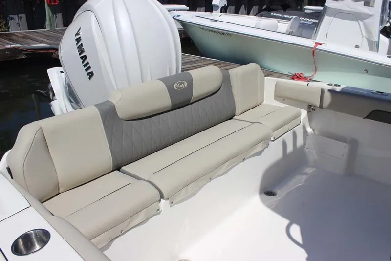 Slide: The Image of 2026 Key West 239 FS boat with Yamaha engine, featuring beige seating and spacious deck. - 23