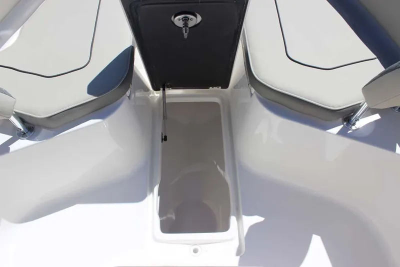 Slide: The Image of 2026 Key West 239 FS boat interior storage compartment with cushioned seating. - 13