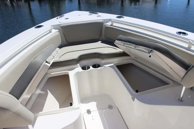 Slide: The Image of 2026 Key West 239 FS boat interior with cushioned seating and storage compartments. - 10