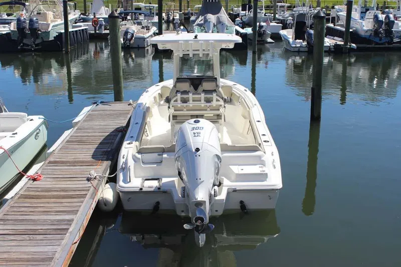 Slide: The Image of 2026 Key West 239 FS boat docked in marina, rear view with outboard motor. - 4