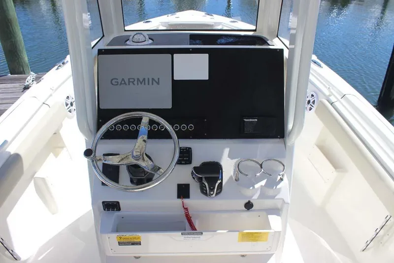 Slide: The Image of 2026 Key West 239 FS boat console with Garmin navigation system and steering wheel. - 18