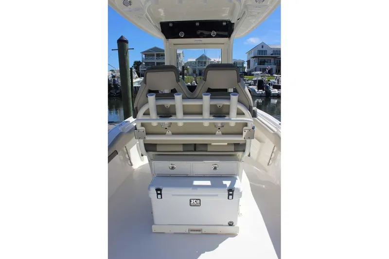 Slide: The Image of 2026 Key West 239 FS boat interior with seating and storage, docked at a marina. - 22