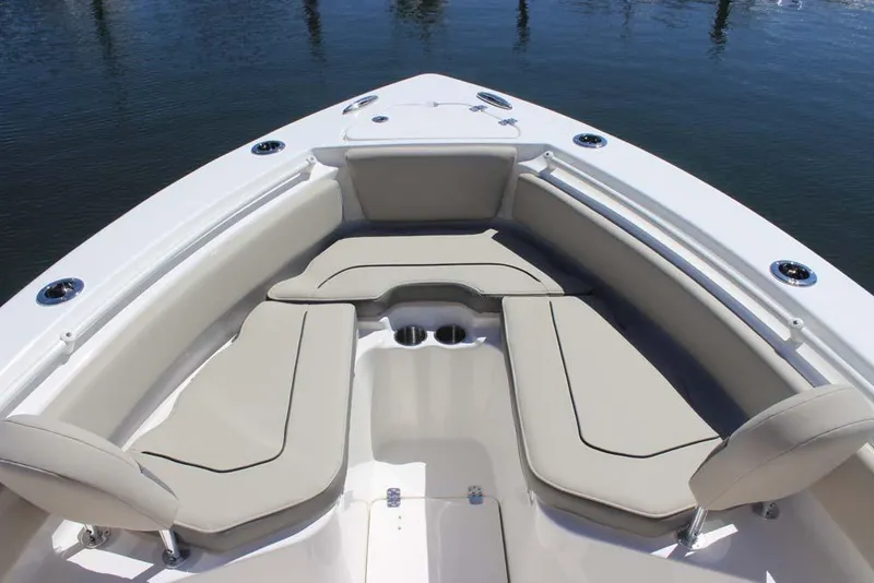 Slide: The Image of 2026 Key West 239 FS boat interior with cushioned seating and cup holders. - 8