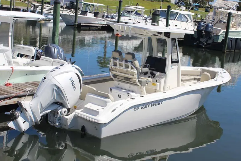 Slide: The Image of 2026 Key West 239 FS boat docked, featuring Yamaha outboard motor, in a marina setting. - 3