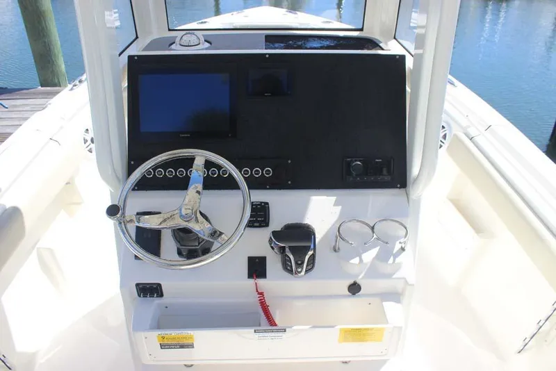 Slide: The Image of 2026 Key West 239 FS boat console with steering wheel and navigation display. - 19