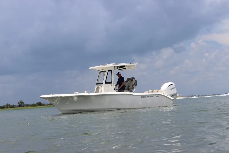 Slide: The Image of 2026 Key West 239 FS boat on water under cloudy sky. - 2