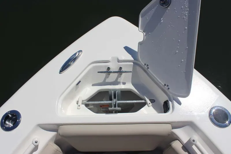 Slide: The Image of Bow anchor compartment of 2026 Key West 239 FS boat, open lid, stainless steel hardware. - 11