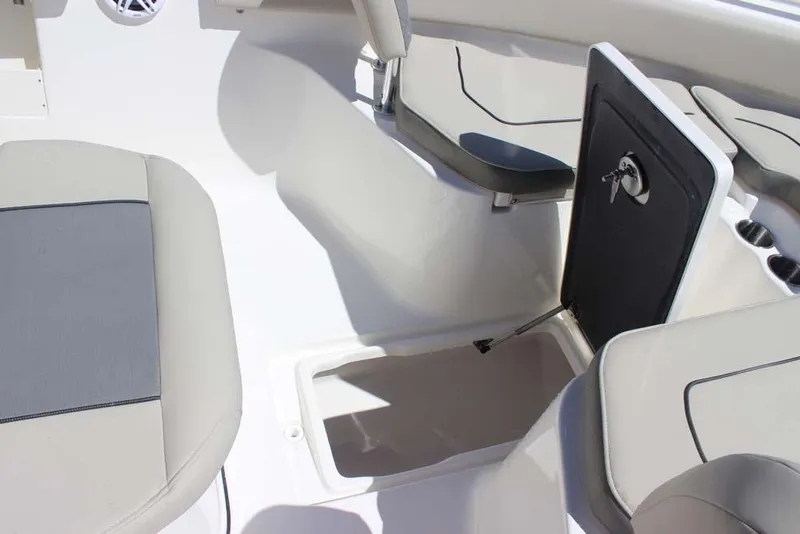Slide: The Image of 2026 Key West 239 FS boat interior with open storage compartment and cushioned seating. - 12