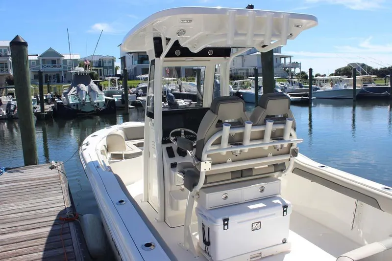 Slide: The Image of 2026 Key West 239 FS boat docked at marina, featuring modern seating and storage. - 6