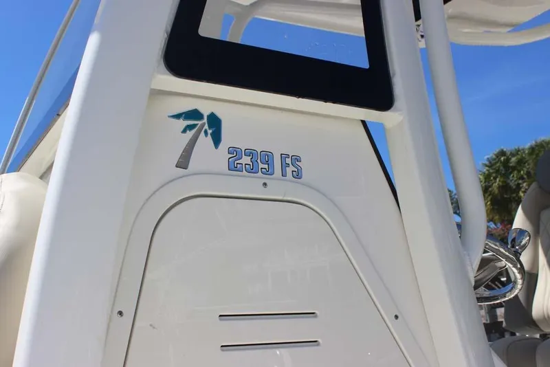 Slide: The Image of 2026 Key West 239 FS boat console with logo and palm tree design. - 16