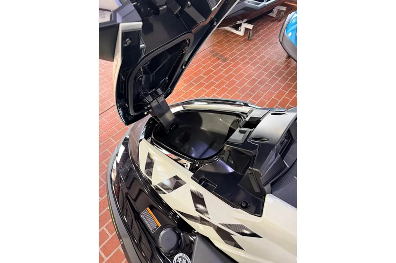 Slide: The Image of 2026 Yamaha WaveRunner VX Cruiser HO with open storage compartment on brick floor. - 11