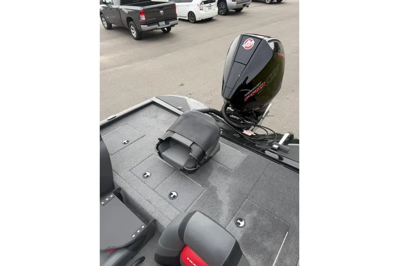 Slide: The Image of 2025 Tracker Savage 215 boat with Mercury engine in parking lot. - 10