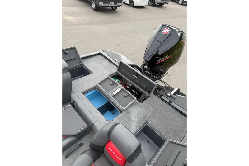 Slide: The Image of 2025 Tracker Savage 215 boat interior with storage compartments and Mercury outboard motor. - 11