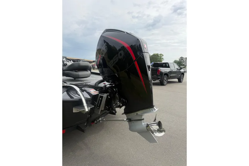 Slide: The Image of 2025 Tracker Savage 215 boat with powerful outboard motor in parking lot. - 4