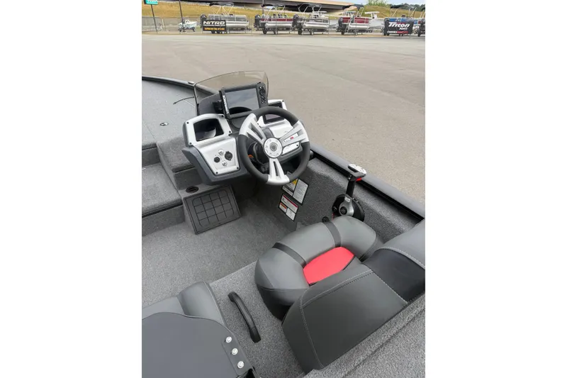 Slide: The Image of Interior of 2025 Tracker Savage 215 boat, featuring steering wheel and control panel. - 9