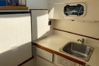 Slide: The Image of 2005 Camano Trawler kitchen with sink, window, and storage cabinets. - 10