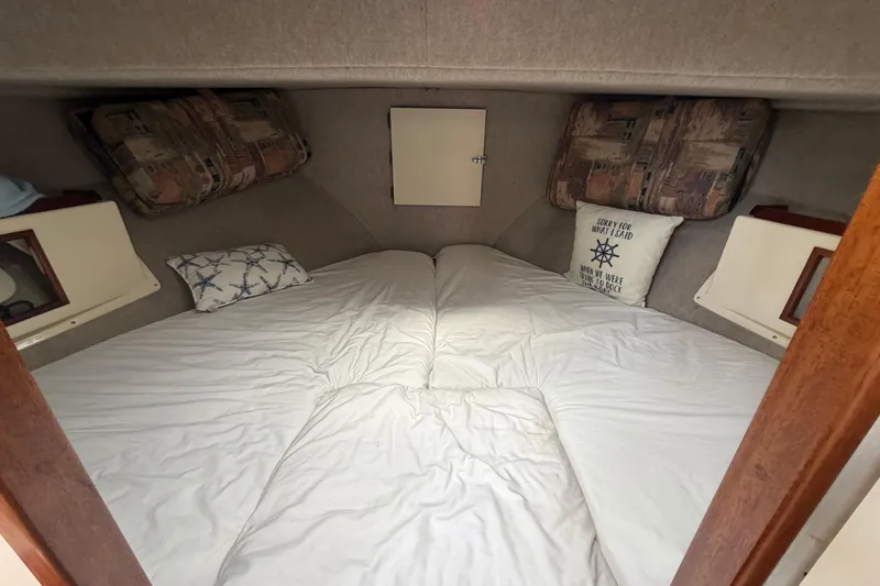 Slide: The Image of Cozy cabin interior of 2005 Camano Trawler with comfortable bedding and nautical-themed pillows. - 13