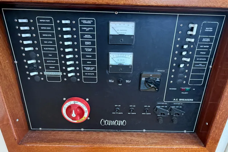 Slide: The Image of Control panel of a 2005 Camano Trawler with switches and gauges. - 14
