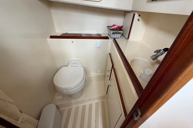 Slide: The Image of Compact bathroom in a 2005 Camano Trawler, featuring a toilet and sink. - 16