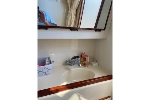 Slide: The Image of 2005 Camano Trawler bathroom sink with mirror and toiletries. - 18