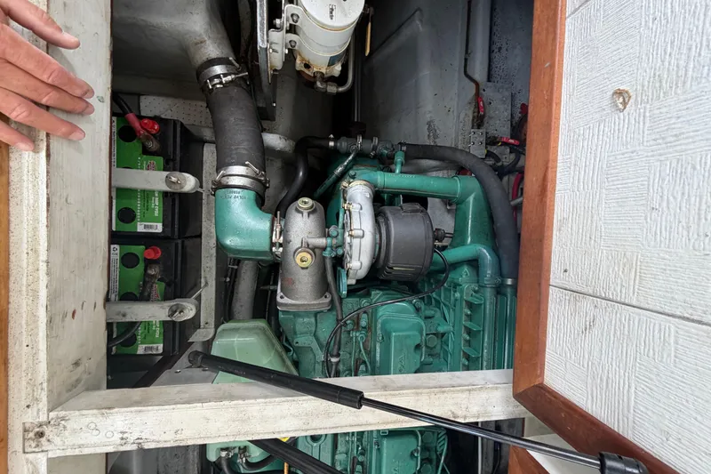 Slide: The Image of Engine compartment of a 2005 Camano Trawler, showcasing mechanical components and batteries. - 20