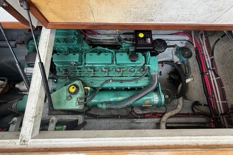 Slide: The Image of Engine compartment of a 2005 Camano Trawler, featuring a Volvo marine engine. - 21