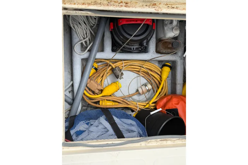 Slide: The Image of Storage compartment of a 2005 Camano Trawler with ropes, cables, and equipment. - 23