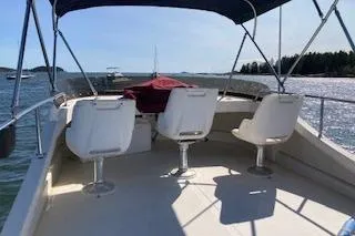 Slide: The Image of 2005 Camano Trawler boat deck with seating, cruising on a sunny day. - 26